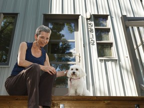 Mildred Thill, a registered dog sitter with the service Go Fetch, poses for a photo with Abbie at her home in Edmonton on Tuesday, July 25, 2017. Ian Kucerak / Postmedia