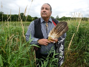 Newly elected Chippewas of the Thames First Nation Chief Myeengun Henry beside the Thames River near Plover Mills Drive, where energy company Enbridge's Line 9 runs on Monday July 24, 2017. (MORRIS LAMONT, The London Free Press)