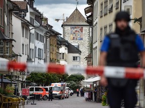 Police and ambulance cars are seen in the old quarter of Schaffhausen, northern Switzerland on July 24, 2017, after a man armed with a chainsaw injured at least five people in an attack. MICHAEL BUHOLZER/AFP/Getty Images