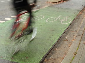 A cyclist using the designated bicycle lane which is separated from vehicle traffic in downtown Vancouver, British Columbia, Canada. (Getty Images)