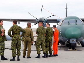 CFB Trenton personnel gather in front of a Brazilian air force C-295W search-and-rescue airplane at the base Wednesday morning. Canada has bought 16 of the planes.