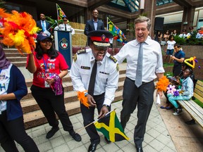 Toronto Police Chief Mark Saunders (left) and Toronto Mayor John Tory share a laugh after speeches were finished during the 2017 Toronto Police Service Caribbean Festival kick-off held in front of the Toronto Police Service headquarters in Toronto, Ont. on Wednesday July 26, 2017. This is the 50th year of the Toronto Caribbean Carnival. Ernest Doroszuk/Toronto Sun/Postmedia Network