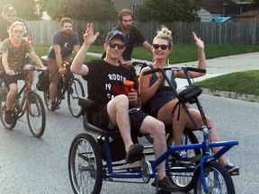 Participants wave as they take part in Community Living Wallaceburg's first-ever 3Rivers Roll held on Wednesday, July 19. Community Living Wallaceburg is planning a second community bicycle ride on Aug. 16.