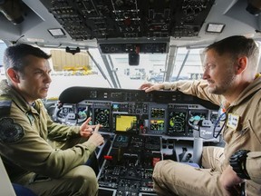 Luke Hendry/The Intelligencer 
Maj. Roberto Sanchez-Solowan, a pilot with Trenton's 426 Squadron, talks with pilot Daniel Varela of Airbus in the cockpit of a Brazilian air force C-295W search-and-rescue aircraft Wednesday at CFB Trenton. Canada has purchased 16 similar aircraft.