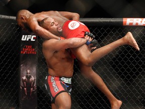 In this Jan. 3, 2015, file photo, Daniel Cormier, bottom, takes down Jon Jones during their light heavyweight title mixed martial arts bout at UFC 182 in Las Vegas. (AP Photo/John Locher, File)