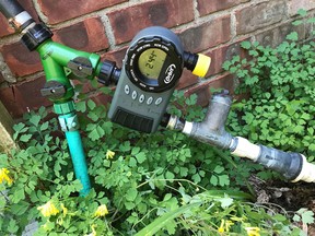 This June 26, 2017 photo shows the beginning portion of a drip irrigation system at a home in New Paltz, N.Y. Watering with drip irrigation has many benefits, not the least of which is that it is easily automated by merely setting a timer. The timer is pictured here along with the filter and pressure reducer that starts water off in any drip irrigation system. (Associated Press file photo)