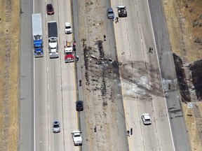 A small plane crashed after it took off from a nearby municipal airport on Interstate 15 in Riverdale, Utah, about 35 miles north of Salt Lake City, Wednesday, July 26, 2017. Authorities say several people died when the plane crashed on a northern Utah interstate median, tangling traffic and leaving blackened wreckage on the highway. (Kristin Murphy/The Deseret News via AP)