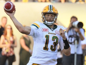 Edmonton Eskimos' quarterback Mike Reilly throws a pass during first half CFL football action against the Hamilton Tiger-Cats in Hamilton, Ont., on Thursday, July 20, 2017.