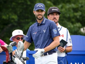 Adam Hadwin of Abbotsford, B.C., discusses club selection on the 17th tee with caddie Joe Cruz during the 2017 Canadian Open Pro-Am in Oakville, Ont., on July 26, 2017. (THE CANADIAN PRESS/David Cooper)