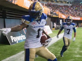 Winnipeg Blue Bombers' Darvin Adams, left, and Weston Dressler celebrate Adams' touchdown against the B.C. Lions during the second half of a CFL football game in Vancouver, B.C., on July 21, 2017. (THE CANADIAN PRESS/Darryl Dyck)