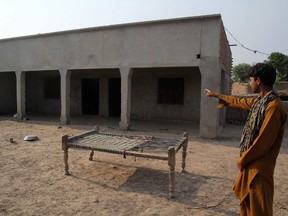 A Pakistani villager poses as he points to a house where a teenage girl was raped in the neighbourhood of Raja Ram in Muzaffarabad, a suburb of the central city of Multan on July 26, 2017. SS MIRZA/AFP/Getty Images