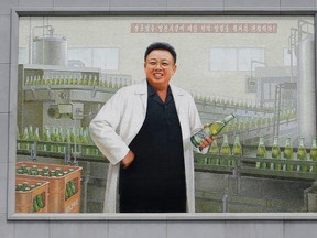 In this Wednesday, July 26, 2017, photo, a mural of the late North Korean leader Kim Jong Il in a white lab coat holding up a bottle of beer is seen at the entrance of the Taedonggang Brewery in Pyongyang, North Korea. Taedonggang beers are generally reputed to be world-class, which is a matter of national pride among many North Koreans. (AP Photo/Wong Maye-E)