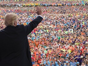 U.S. President Donald Trump waves to the crowd after speaking at the 2017 National Scout Jamboree in Glen Jean, W.Va., on Monday, July 24, 2017. (Carolyn Kaster/AP Photo)