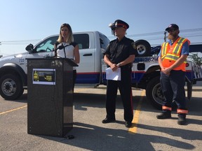 CAA's Liz Kulyk, Staff Sergeant Rob Riffel of the WPS, and tow-truck driver Jason Miller say motorists need to do a better job giving crews space when passing on the roadside. (Jason Friesen/Winnipeg Sun/Postmedia Network)