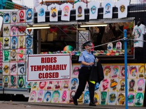 An Ohio State Highway Patrol cadet patrols the midway at the Ohio State Fair Thursday, July 27, 2017, in Columbus, Ohio. (AP Photo/Jay LaPrete)