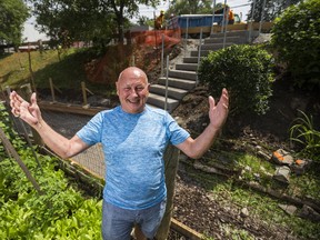 Resident Adi Astl is all smiles as City of Toronto workers build a staircase at Tom Riley Park on Thursday, July 27, 2017. Astl had earlier constructed a staircase in the same spot for $550. (ERNEST DOROSZUK/TORONTO SUN)
