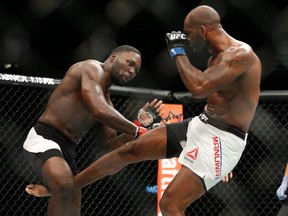 Anthony Johnson gets kicked by Jimi Manuwa during their light heavyweight mixed martial arts bout at UFC 191 on Saturday, Sept. 5, 2015, in Las Vegas. (AP Photo/John Locher)