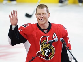 Ottawa Senators' Chris Neil salutes the crowd during a ceremony to mark his 1,000th NHL game prior to NHL action against the San Jose Sharks on Dec. 14, 2016. (THE CANADIAN PRESS/Adrian Wyld)