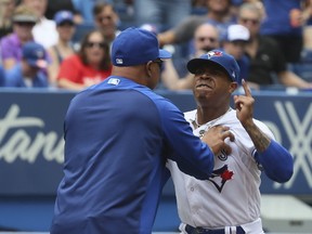Jays starter Marcus Stroman is restrained by coach DeMarlo Hale after being ejected during Thursday's game. (VERONICA HENRI/Toronto Sun)