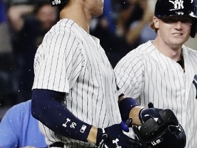 Yankees' Aaron Judge reacts after he is hit by the helmet of Brett Gardner after the team's game against the Rays in New York on Thursday, July 27, 2017. Judge was hit in the mouth and broke a tooth during the celebration, Yankees manager Joe Girardi said. (Frank Franklin II/AP Photo)