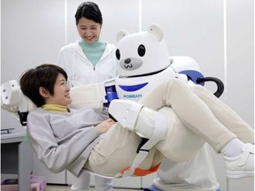 "Robear" lifts a woman for a demonstration in Nagoya, central Japan. Welcome to the new age of elder care, the age of robots. JIJI PRESS / AFP/GETTY IMAGES