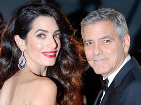 In this Feb. 24, 2017, file photo actor George Clooney and Amal Clooney arrive at the 42nd Cesar Film Awards ceremony at Salle Pleyel in Paris. George Clooney said in a statement on July 28, 2017, that photographers who captured images of him and his wife, human rights lawyer Amal Clooney, cradling their newborn twins will be “prosecuted to the fullest extent of the law.” (AP Photo/Francois Mori, File)