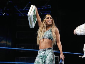 WWE Superstar Carmella celebrates with the Money in the Bank briefcase after becoming the first woman to hold the coveted prize, which guarantees its holder a shot at the Smackdown Women’s Championship, any place, any time. Carmella will bring her briefcase to Kingston on Aug. 7 as part of WWE’s SummerSlam Heatwave Tour at the Rogers K-Rock Centre.  (Courtesy of World Wrestling Entertainment)