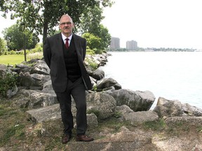 Tom Wolfe with DJ Robb Funeral Home stands near the water's edge in Sarnia's Point Lands, the spot where a proposed scattering area for cremated remains is proposed. City council is scheduled to vote on the proposal Monday. (Tyler Kula/Sarnia Observer)