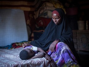 Amran Mahamood, who has made a living for 15 years by circumcising young girls, sits next to a girl on February 19, 2014 in Hargeysa. Four years ago, she gave it up after a religious leader convinced her the rite was not required by Islamic law. The centuries old tradition of female circumcision, also known as female genital mutilation (FGM), is on the decline in northern Somalia, though it continues to have some of the highest rates of women who have undergone the practice in the world. (Nichole Sobecki/AFP/Getty Images)