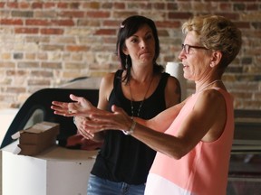 Premier Kathleen Wynne talks to a business owner during a stop in Woodstock this week. Whether it?s minimum wage, Hydro One or access to health care, letter writers are not happy with the premier. (BRUCE CHESSELL, Postmedia News)
