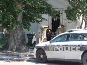 Police officers outside of a residence in the 100 block of Euclid Avenue in Winnipeg on Friday, July 28, 2017, where a 29-year-old male and a 31-year-old female were found suffering stab wounds. The victims were transported to hospital in critical condition. The female has since been upgraded to stable condition; however, the male died from his injuries. SCOTT BILLECK/Winnipeg Sun/Postmedia Network