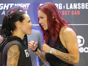 Brazil's Cristiane Justino, known as "Cris Cyborg," right, and Sweden's Lina Lansberg pose for photos at an event promoting an upcoming UFC Fight Night in Brasilia, Brazil, on Sept. 22, 2016. (AP Photo/Eraldo Peres)