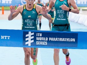 Australia's Katie Kelly celebrate's her win at the ITU World Triathlon Edmonton, Friday July 28, 2017. Kelly is pictured with her guide Michellie Jones, right.