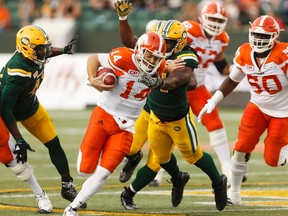 BC's quarterback Travis Lulay is tackled by Edmonton's Euclid Cummings (94) during a CFL game between the Edmonton Eskimos and the BC Lions at Commonwealth Stadium in Edmonton on Friday, July 28, 2017.