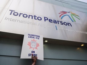 Striking workers are seen picketing at Pearson International Airport in Toronto on Friday, July, 28, 2017. Ground crew workers at Pearson airport have walked off the job after rejecting the latest offer from Swissport. Picket lines have been set up at Pearson's Terminal 3 and a cargo terminal near Swissport's administrative offices. THE CANADIAN PRESS/Christopher Katsarov