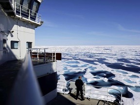 In this Saturday, July 22, 2017 photo, Canadian Coast Guard Capt. Victor Gronmyr looks out over the ice covering the Victoria Strait as the Finnish icebreaker MSV Nordica traverses the Northwest Passage through the Canadian Arctic Archipelago. (David Goldman/AP Photo)