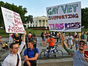 Protesters gather in front of the White House July 26, 2017, in Washington, DC. Trump announced on July 26 that transgender people may not serve "in any capacity" in the US military, citing the "tremendous medical costs and disruption" their presence would cause. PAUL J. RICHARDS/AFP/Getty Images