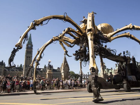 Kumo, the spider, passes Parliament Hill on Wellington St. during a La Machine performance Saturday, July 29 2017.