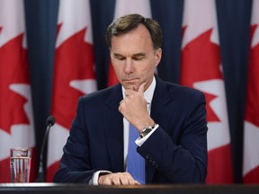 Minister of Finance Bill Morneau holds a press conference at the National Press Theatre in Ottawa on Tuesday, July 18, 2017. THE CANADIAN PRESS/Sean Kilpatrick