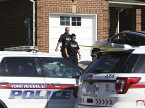 York Regional Police investigate a murder on Tall Grass Trail in Woodbridge, on Saturday July 29, 2017. (Stan Behal/Toronto Sun)