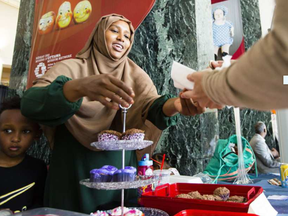 Hamdi Ahmed sells cupcakes at her table at the inaugural Somali Cultural Festival in Jean Pigott Place on Saturday, July 29, 2017.DARREN BROWN / POSTMEDIA