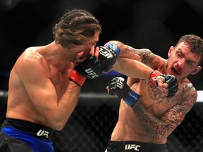 Renato Moicano (right) lands a punch on Brian Ortega during their featherweight bout at UFC 214 in Anaheim on Saturday night.