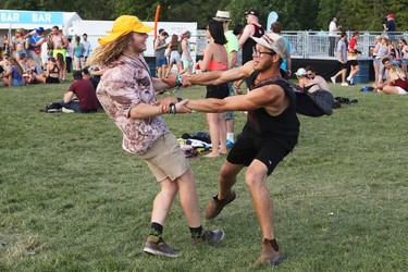 KEVIN LAMB PHOTO 
Luke Marquis of Adelaide, Australia, left, swings around in circles to the music with Dan Pearce of Norland, Ontario at the WayHome Music & Arts Festival at Burl's Creek Event Grounds in Oro on Saturday, July 29th, 2017.
