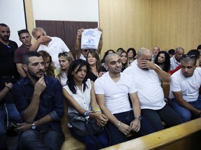 Elor Azaria (center) flanked by his parents, sits inside an Israeli military court in Tel Aviv on Sunday, July 30, 2017. (Dan Balilty/AP Photo/Pool)