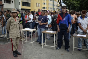 Venezuelans line up to cast their ballot at a polling station in Caracas on July 30, 2017. FEDERICO PARRA/Getty Images