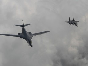 In this photo provided by South Korea Defense Ministry, a U.S. Air Force B-1B bomber, left, flies with a South Korean fighter jet F-15K over the Korean Peninsula, South Korea, Sunday, July 30, 2017. (South Korea Defense Ministry via AP)