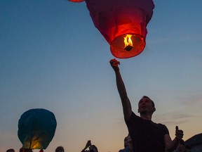 About 50 Chinese Lanterns were released into the night sky as a  tribute to Khrystyna Maksymova who drowned in a drainage pond in the north Edmonton community of Chrystallina Nera while trying to save the dog she was walking. on July 30, 2017.  Photo by Shaughn Butts / Postmedia