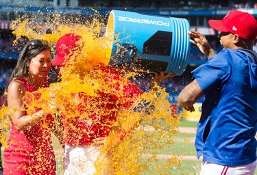 Toronto Blue Jays Steve Pearce gets a gatorade shower from teammates while be interviewed by Sportsnet's Hazel Mae after hitting a walk off grand slam to defeat the Los Angeles Angels in their AL baseball game in Toronto on Sunday July 30, 2017. THE CANADIAN PRESS/Fred Thornhill ORG XMIT: FJT16