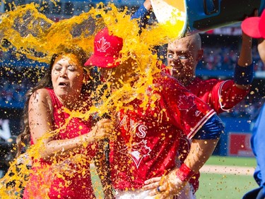 Toronto Blue Jays Steve Pearce gets a gatorade shower from teammates while be interviewed by Sportsnet's Hazel Mae after hitting a walk off grand slam to defeat the Los Angeles Angels in their AL baseball game in Toronto on Sunday July 30, 2017. THE CANADIAN PRESS/Fred Thornhill ORG XMIT: FJT18