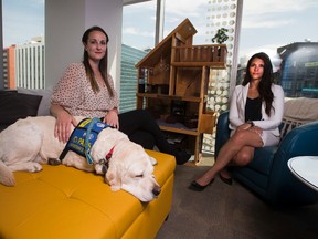 Sam Dover and Kim Clark, two of the Zebra Centre's lead child advocates talk about Statistics Canada data that shows sexual crimes against children are on the rise. Therapy dog Wren is also in the picture, taken July 27, 2017.